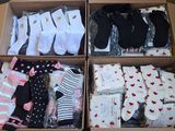 many pairs of socks in a box on a table