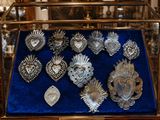 a display case with a lot of silver items in it