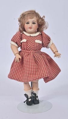 a doll that is wearing a red dress and black shoes