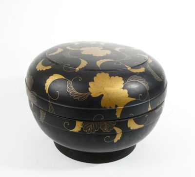 a black box with gold designs on it on a white surface