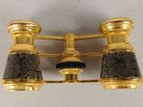 pair of brass plated binoculars with black and gold shades
