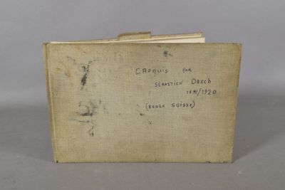 an old book with writing on it sitting on a table
