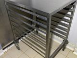 a metal table that is on wheels in a kitchen