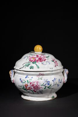 an image of a white bowl with flowers on it on a black surface