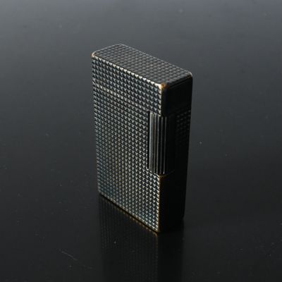 an image of a lighter sitting on a black surface