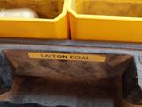 yellow bins are stacked on top of each other on a pallet
