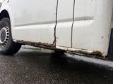 a white van that is parked on the side of the road
