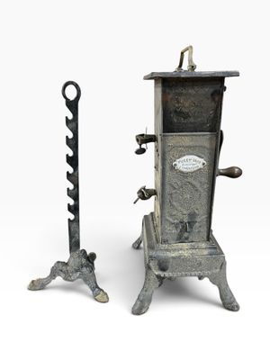 pair of antique cast iron coaling stoves with cast iron handles