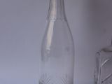 a glass bottle and a glass bottle on a table