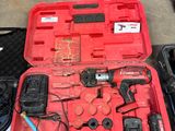 a red tool case with tools in it on the floor