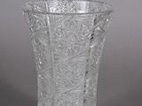 pair of cut glass vases with floral designs on the sides