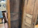 a wooden cabinet with a door open in a room