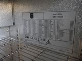 a picture of a metal shelf with a sign on it