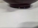 a brown bowl sitting on a table with a white table cloth