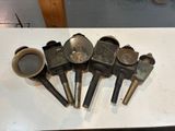 four different types of gas valves on a white table