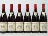six bottles of red wine are lined up in a row