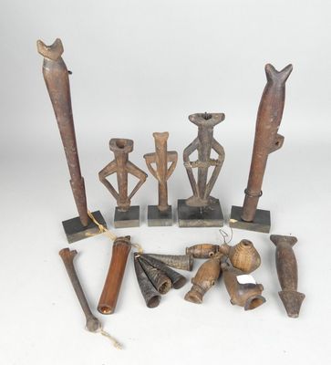 several pieces of african art are displayed on a white surface