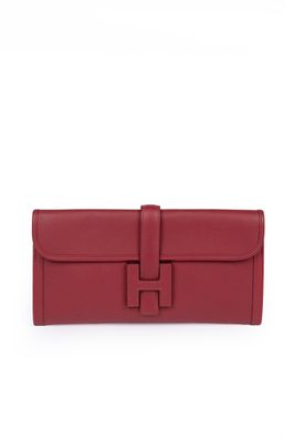 a red leather wallet with a metal clasp on the front
