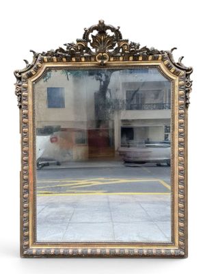 a large mirror that is sitting on the side of the road