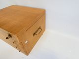 une petite boîte en bois munie d'une poignée