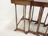 three wooden tables are sitting side by side on a white floor