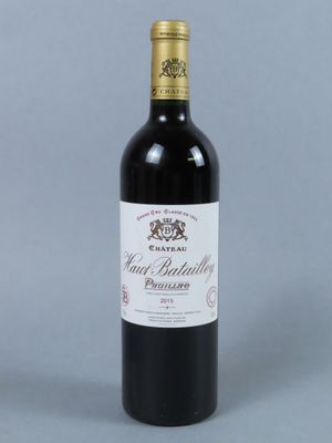 a bottle of red wine with a gold cap on top