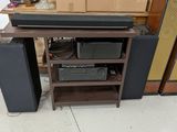 a wooden shelf with speakers and a stereo on top of it