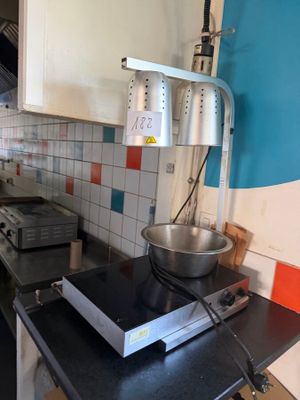 a kitchen with a stove, stove top, and a bowl on the counter
