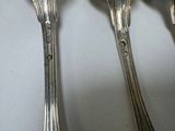 four spoons that are sitting on a table