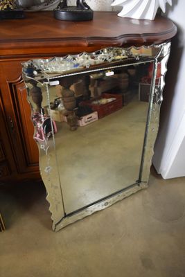 a mirror that is sitting on top of a dresser