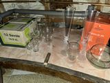 a table that has a bunch of glasses and a box on it