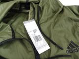 a green jacket with a tag attached to it