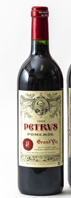 two bottles of wine sitting next to each other on a table