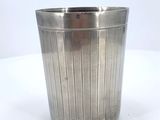 a metal trash can that is sitting on a table
