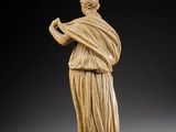 a statue of a woman holding a bird in her hand