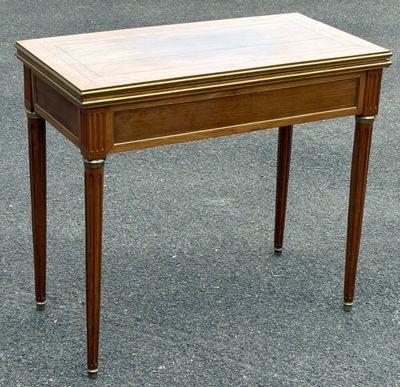 a small wooden table with a marble top on it