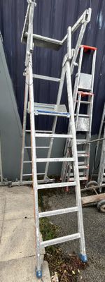 a ladder that is leaning against a building