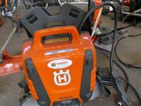 an orange and black blower sitting on the ground