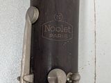 a close up of a bassoon on a white wall