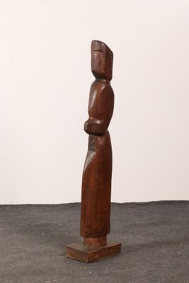 an image of a wooden sculpture of a woman standing on a pedestal