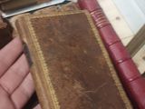 a person that is holding a book on a table