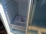 a small refrigerator that has a door open on a pallet