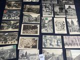 several old black and white photos of people and buildings on a table