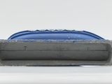 a close up of a blue toothbrush on a white surface