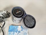 a camera, a lens, and a book on a table