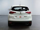 the rear end of a white car in a white room