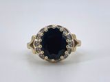 a close up of a ring with a black stone in it
