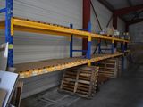 many shelves in a warehouse with pallets on them