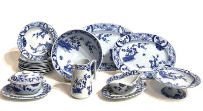 many blue and white plates and cups on the table