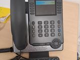 a telephone that is sitting on a desk next to a keyboard